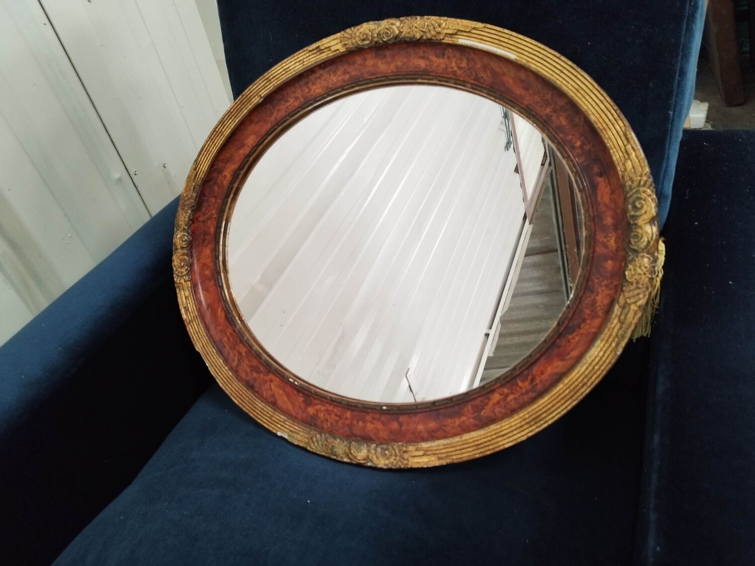 Golden oval art deco mirror