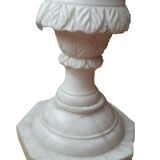 Saddle column in fluted white marble with floral motifs.