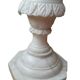Fluted white marble stand column with floral motifs.