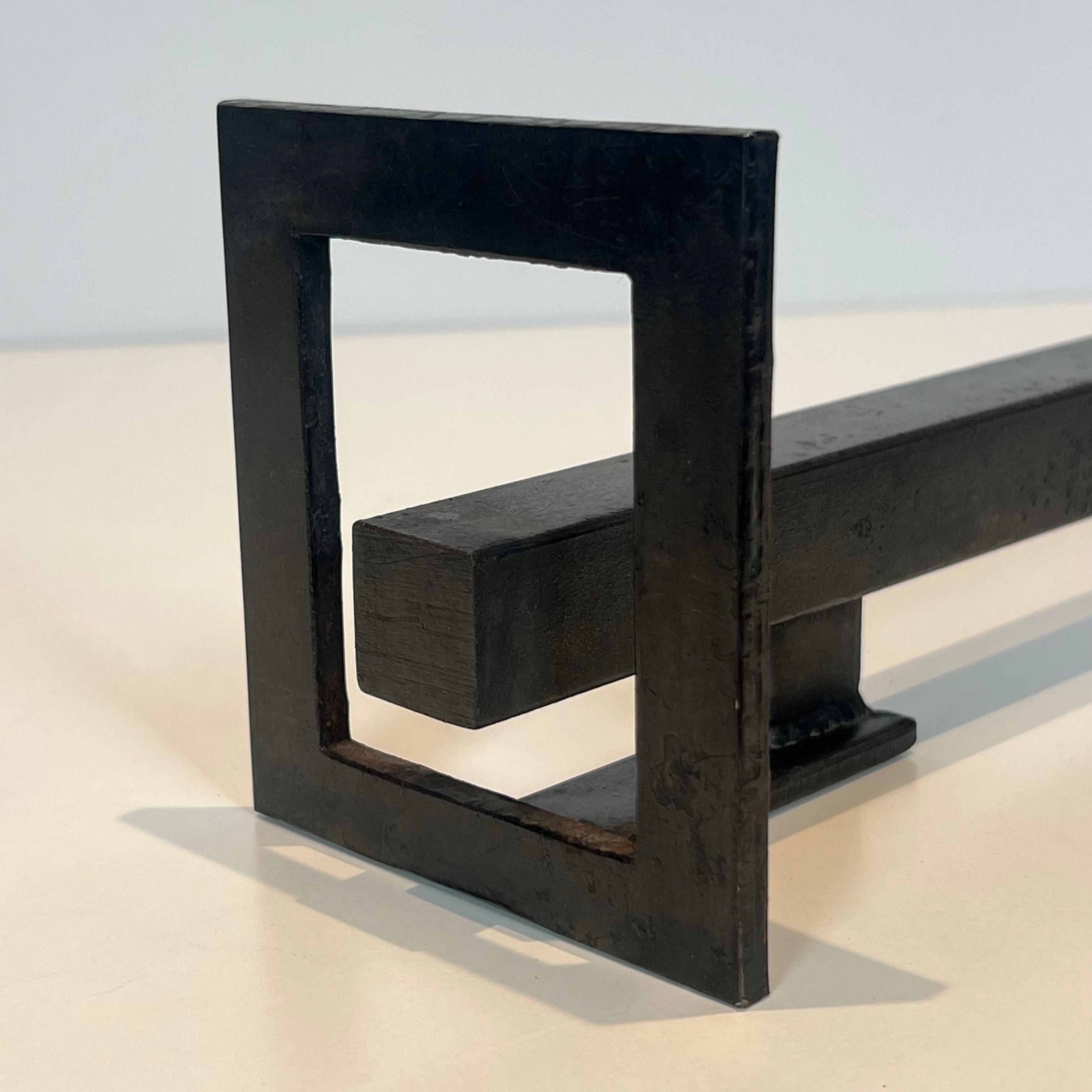 Pair of modernist andirons in steel and wrought iron