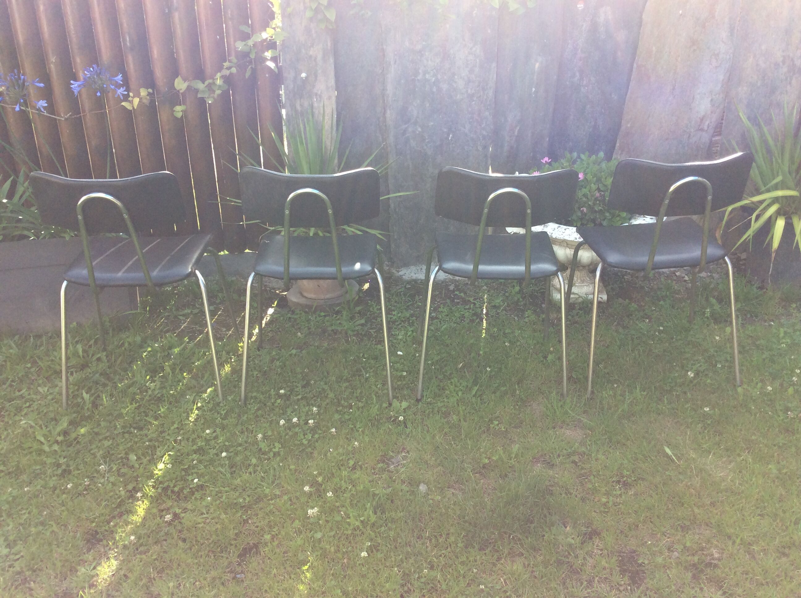 4 Chairs with chrome tubular metal base and black Skaï