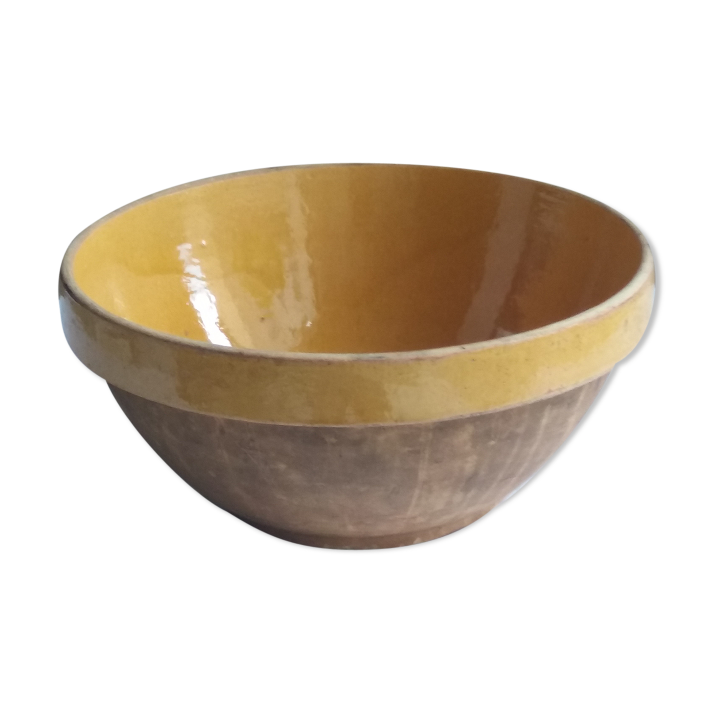 Large old salad bowl in yellow varnished earth