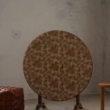 19th-century French round wine table with an adjustable top and floral textile surface.