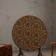 19th-century French round wine table with an adjustable top and floral textile surface.