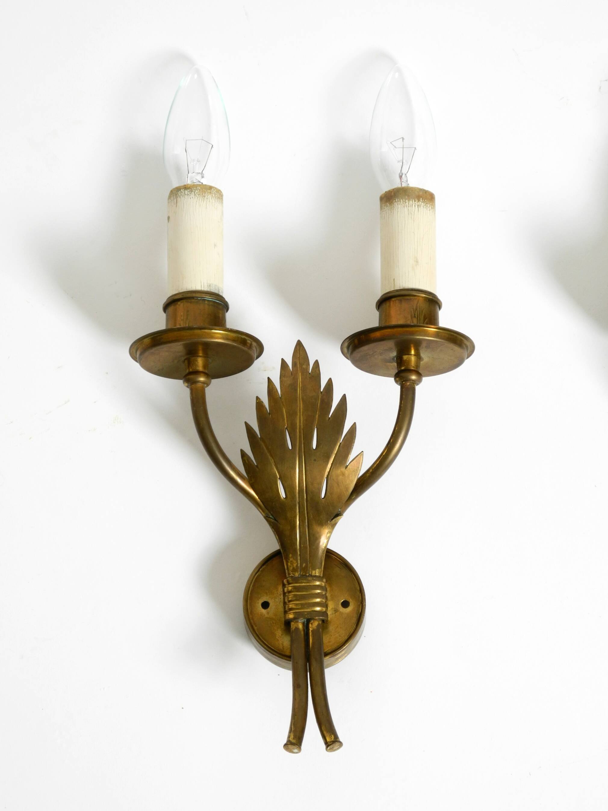 A pair of mid-century modern brass wall lamps by Vereinigte Werkstätten