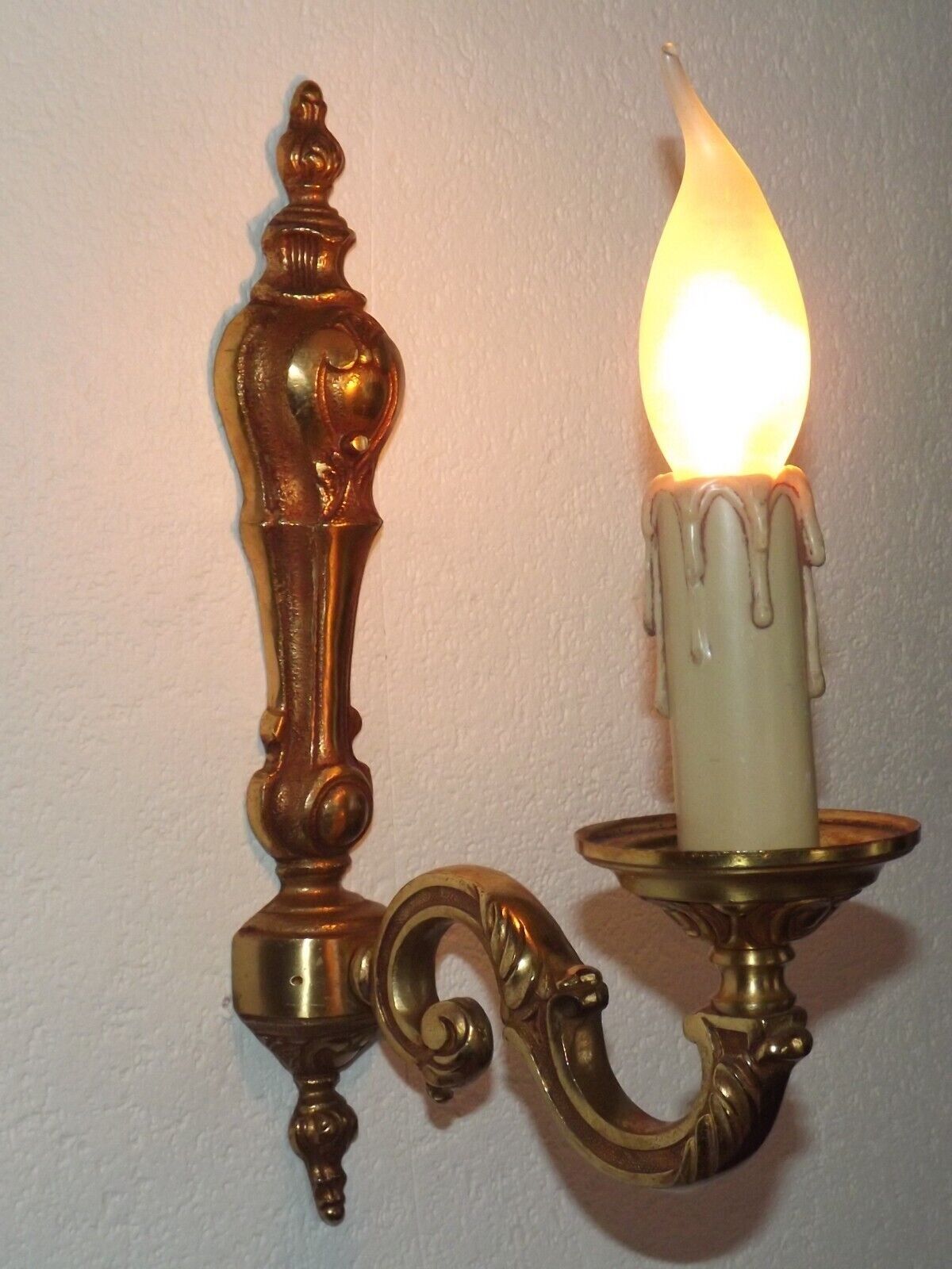 Simple wall sconce in classic Empire style in vintage French bronze.