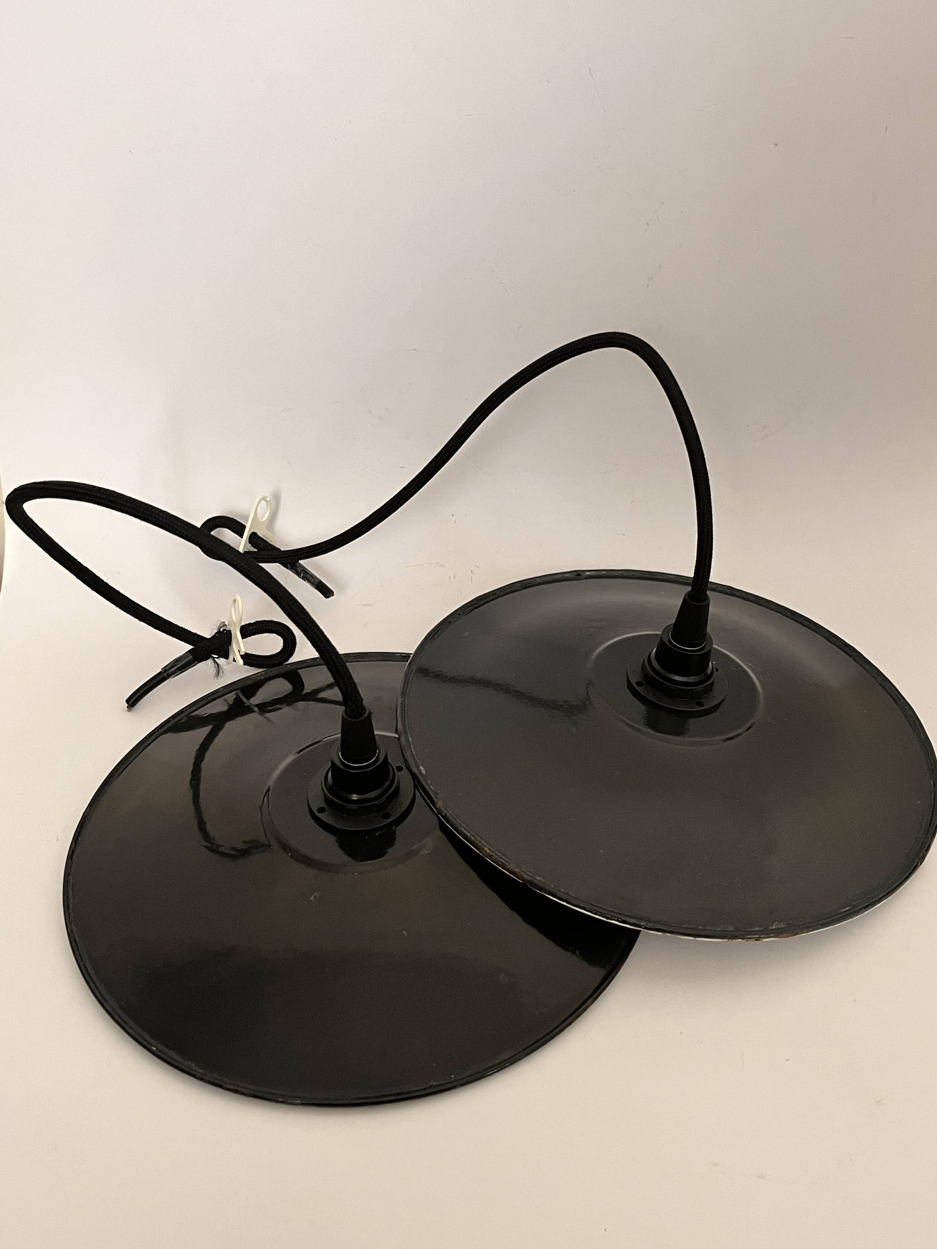 Pair of black enamelled metal bowls