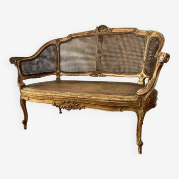 Canapé en bois doré, canné, d'époque XIX ème de style Louis XV