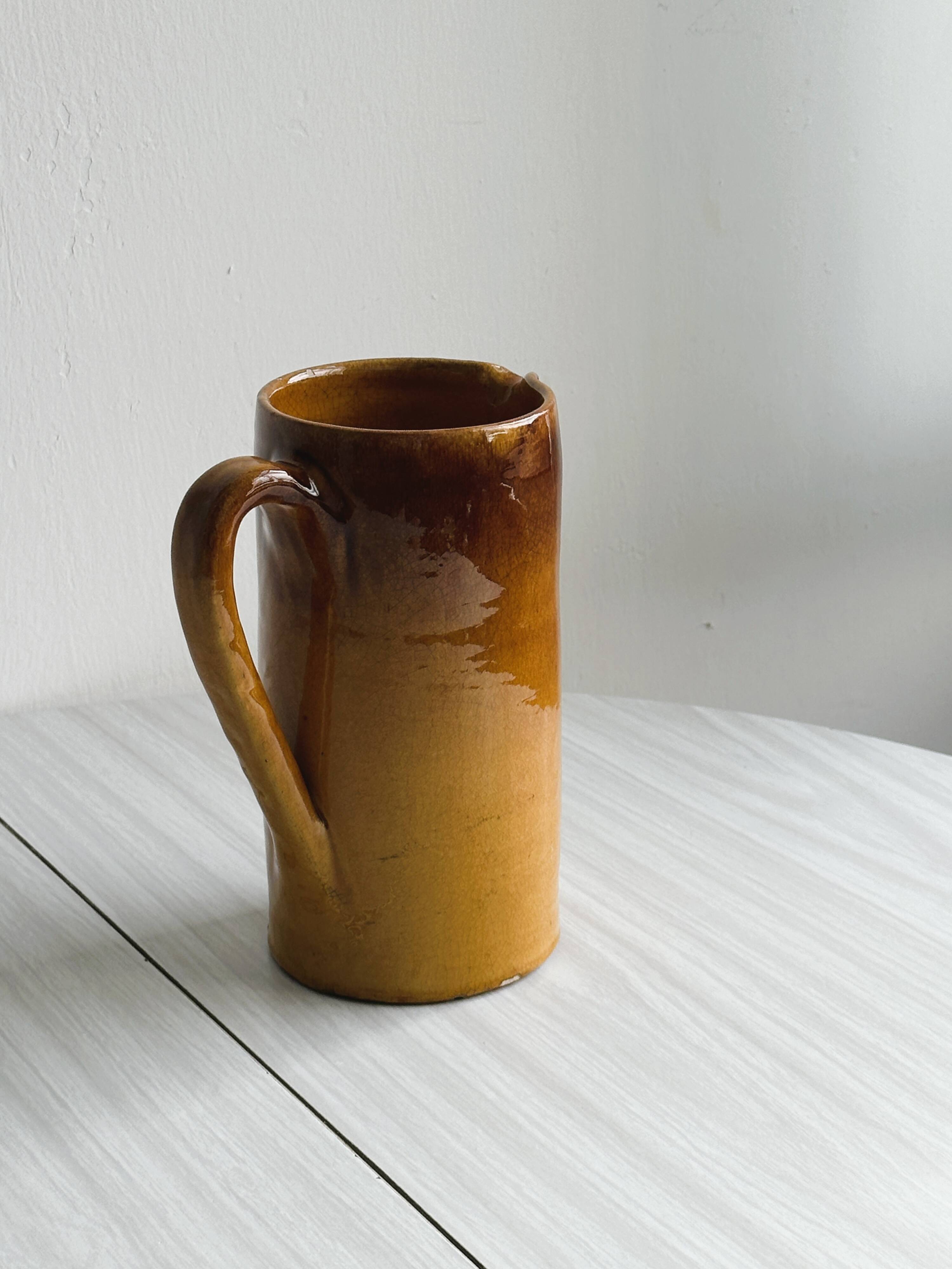 Vintage enameled ceramic watering can vase - retro mustard yellow pot.