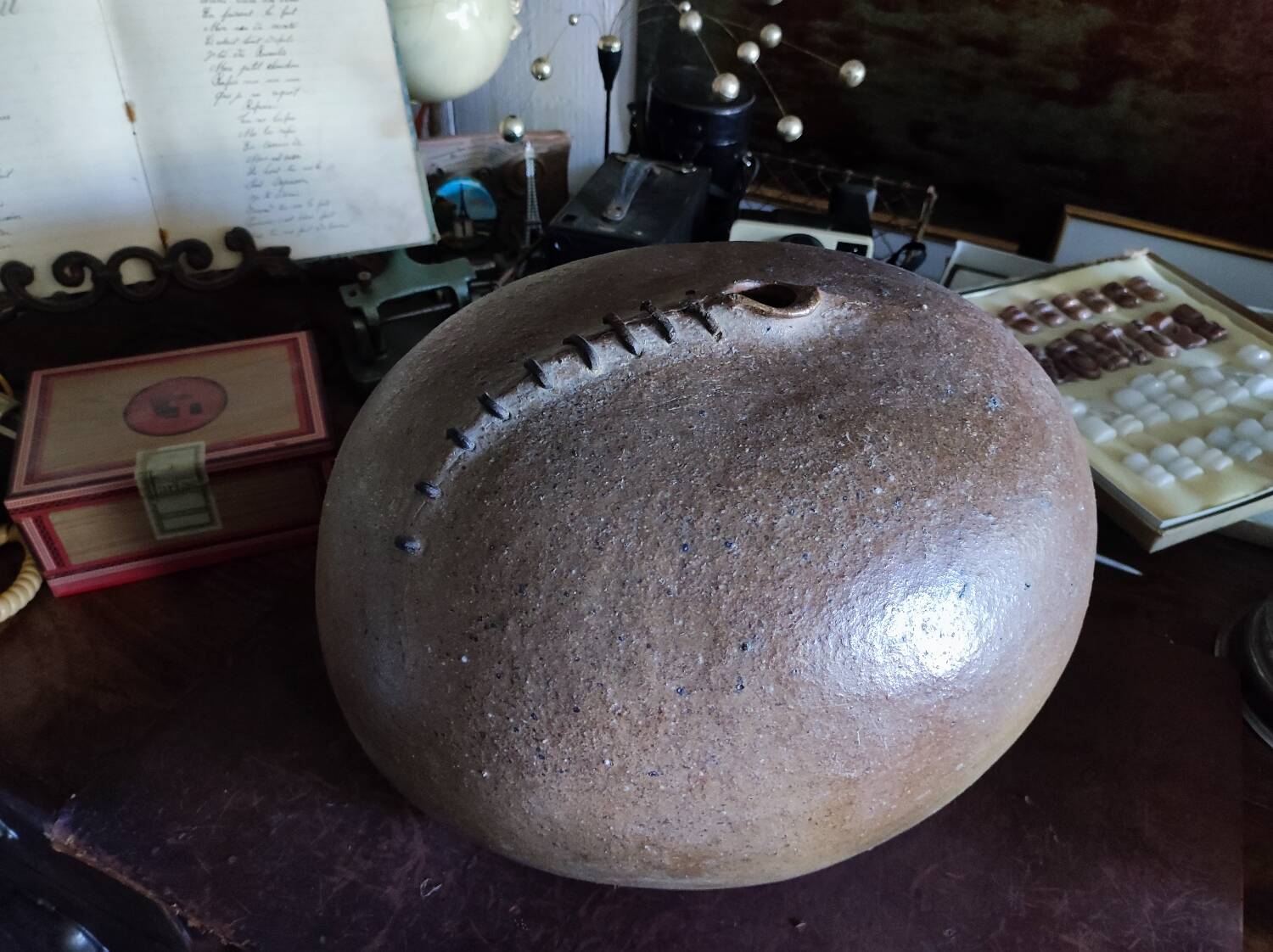 Vintage sandstone vase, in the shape of a rugby ball, signed