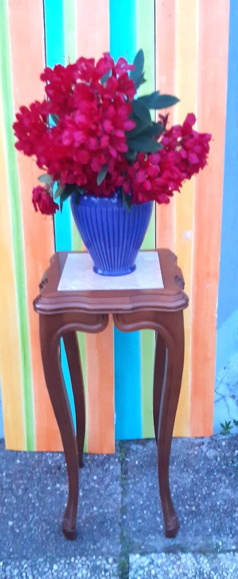Curved leg wooden stand with a marble top.