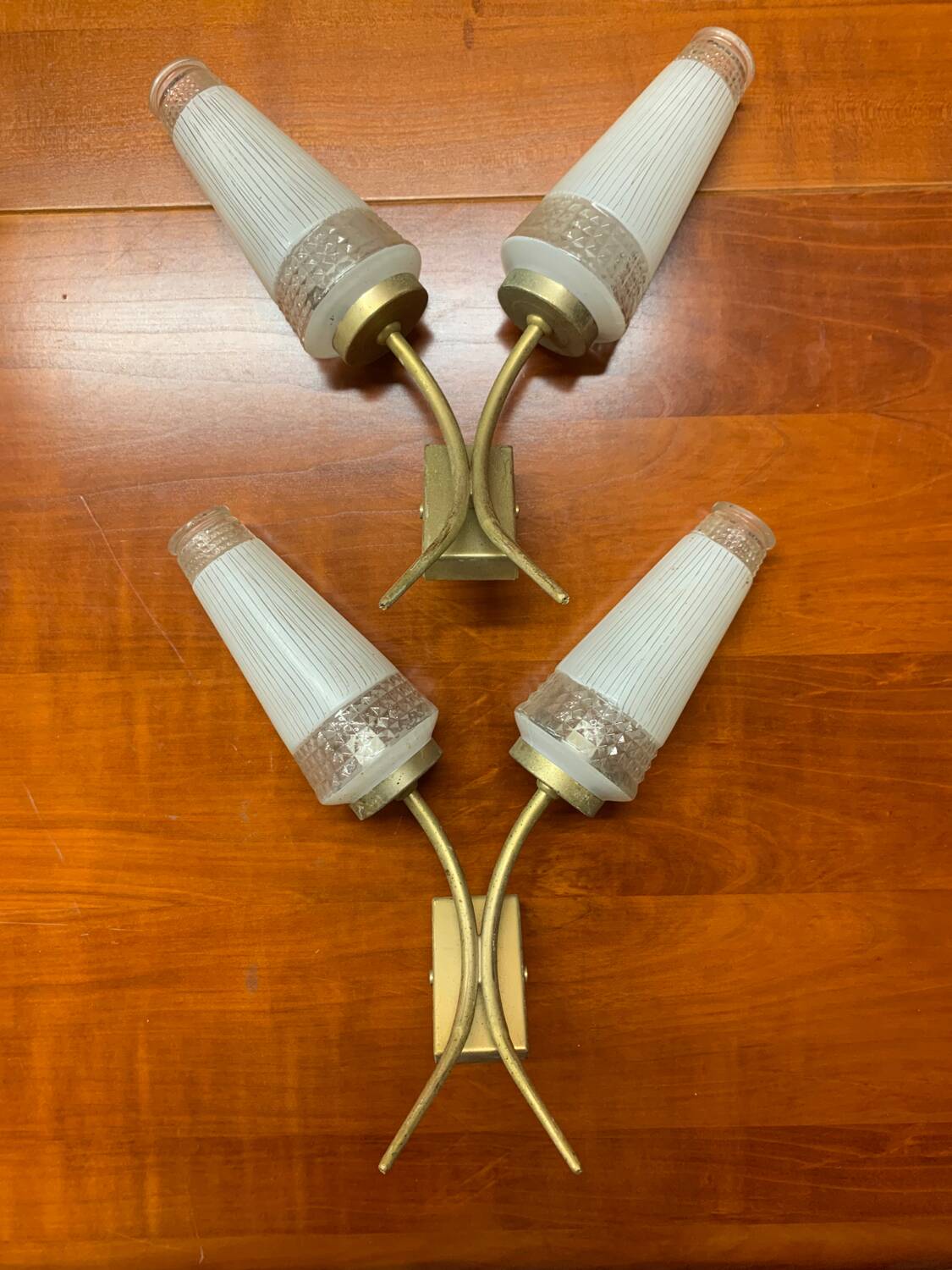 Pairs of brass sconces, ear-shaped tulips in opaline glass from the 1950s
