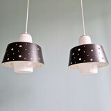 A pair of Scandinavian pendant lights in white opaline and black lacquered metal, 1960.