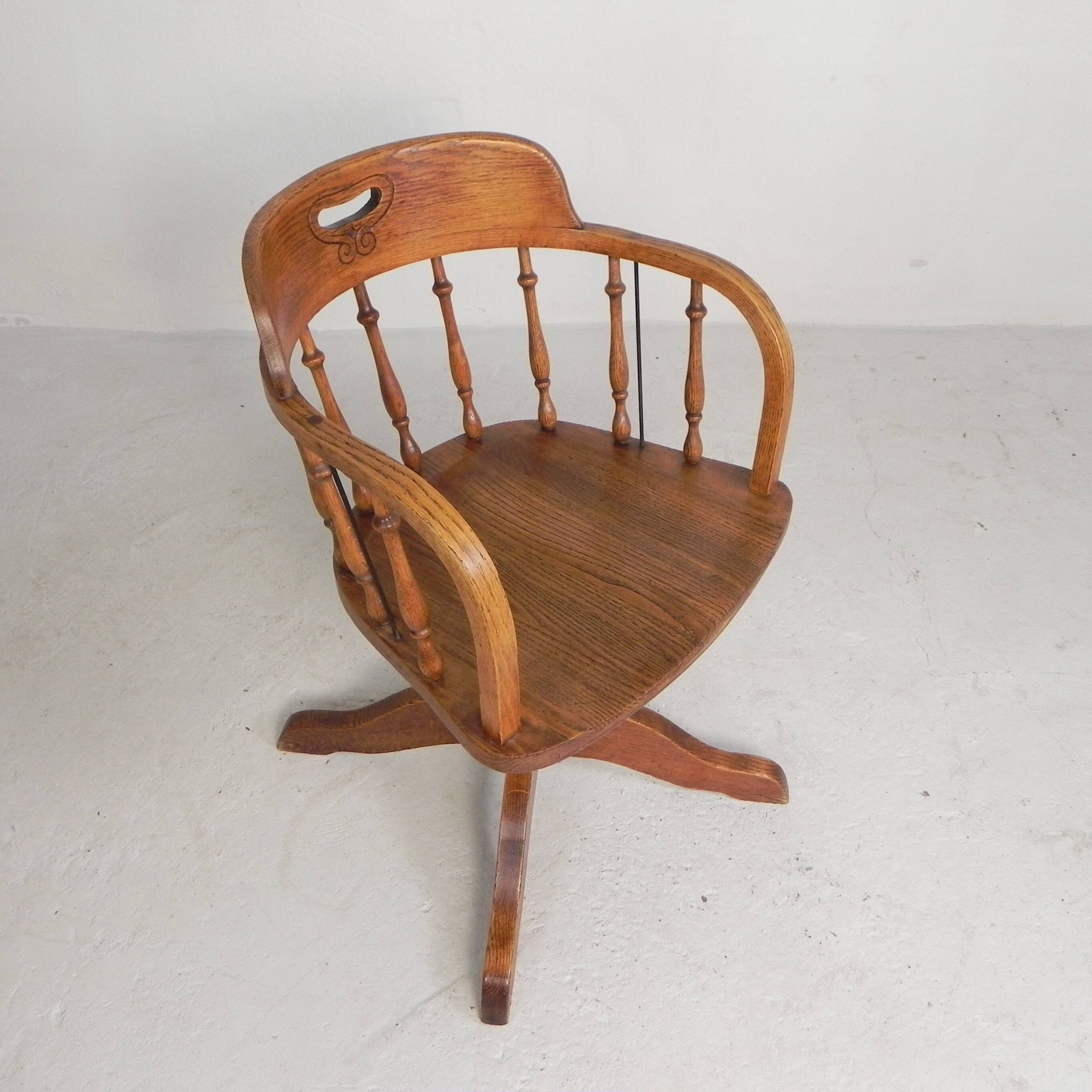 Oak office chair with a spring system and height adjustable, 1930s.