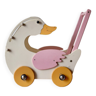 Vintage wooden doll's pram in the shape of a goose