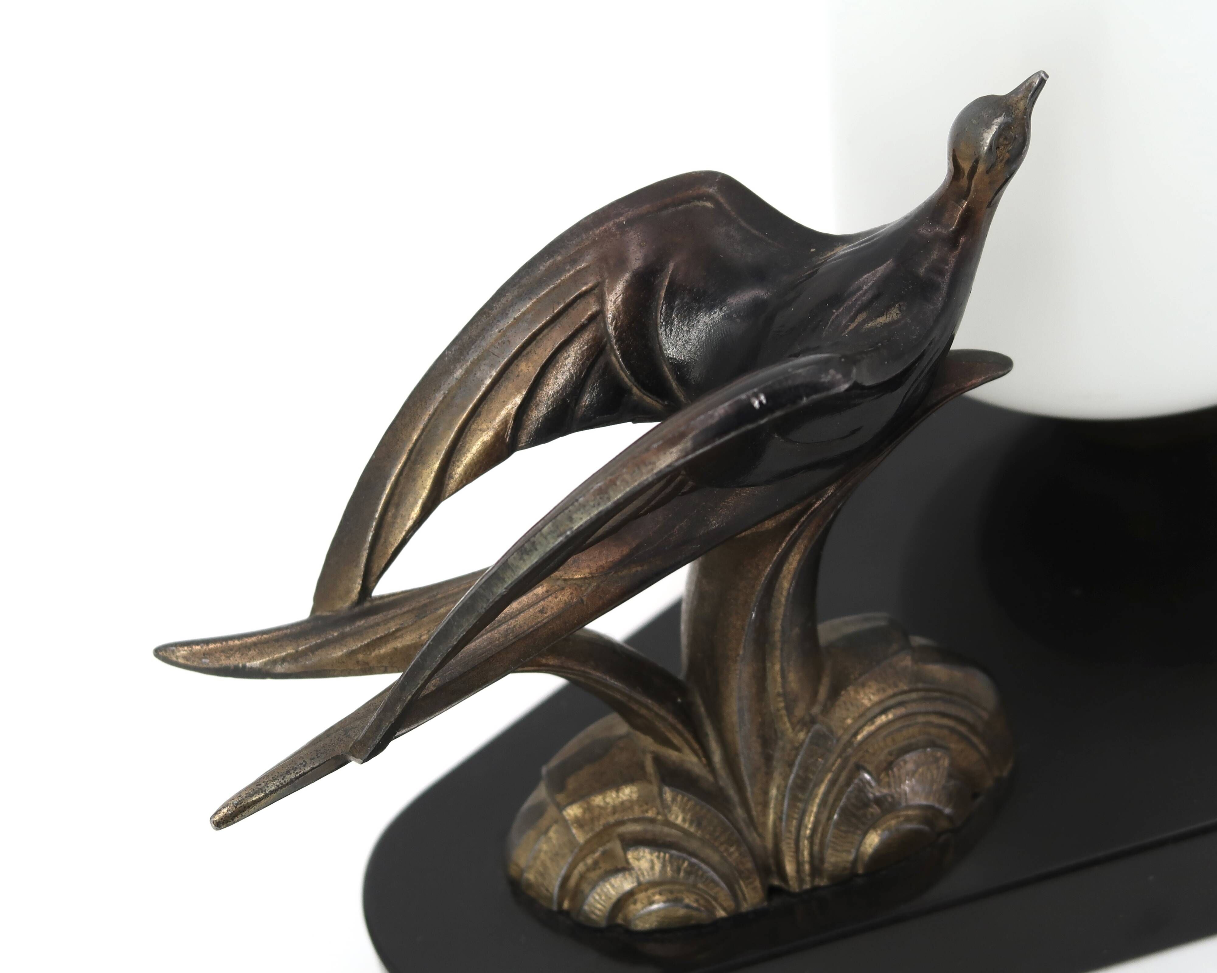 Art Deco lamp with swallow sculpture, marble base, opaque white globe.