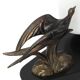 Art Deco lamp with swallow sculpture, marble base, opaque white globe.