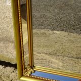 Hall mirror, gilded frame with fillets and fleur-de-lis.