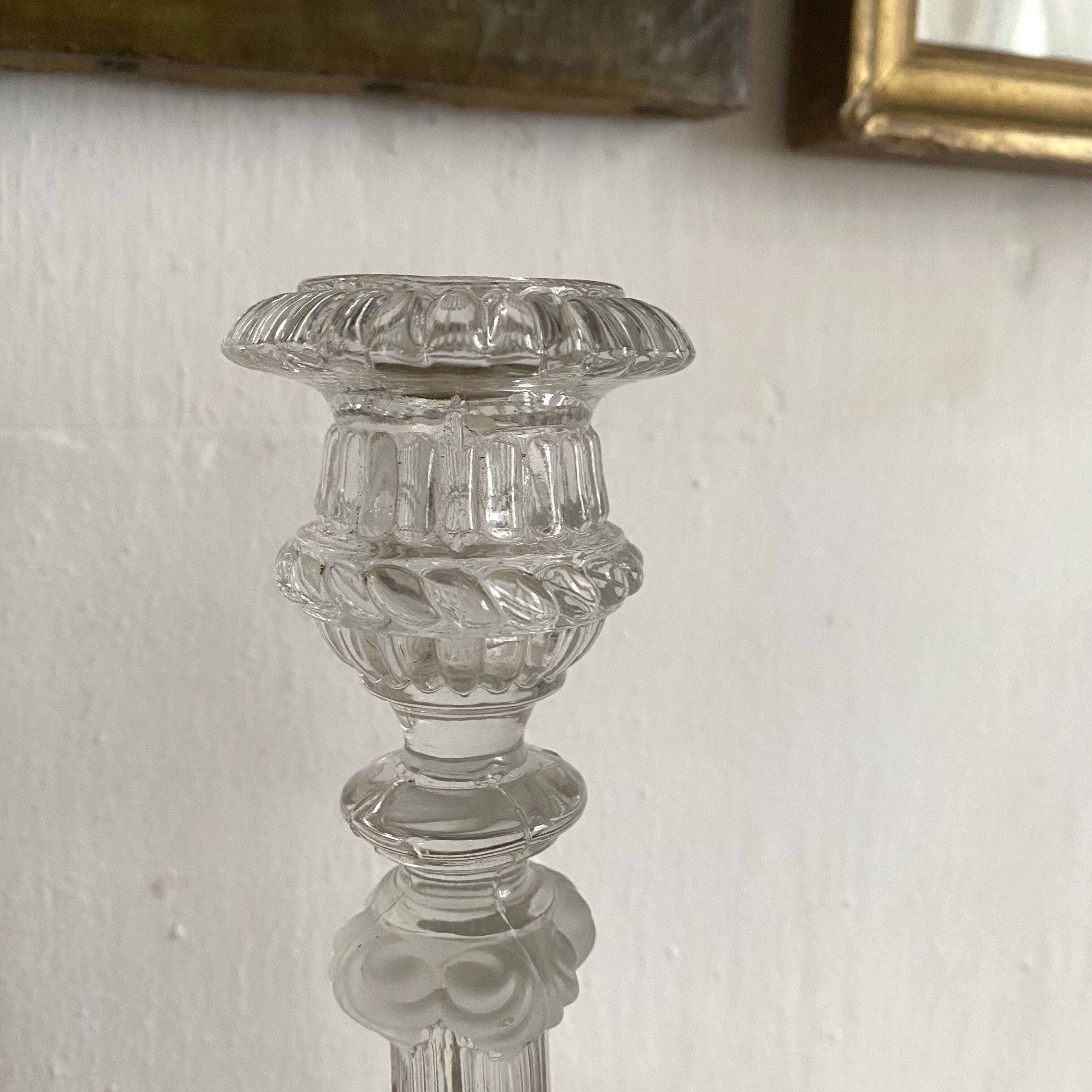 Pair of moulded glass candlesticks, ram heads and masks