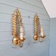 Pair of gold metal wall sconces in Hollywood Regency style, 1970s.