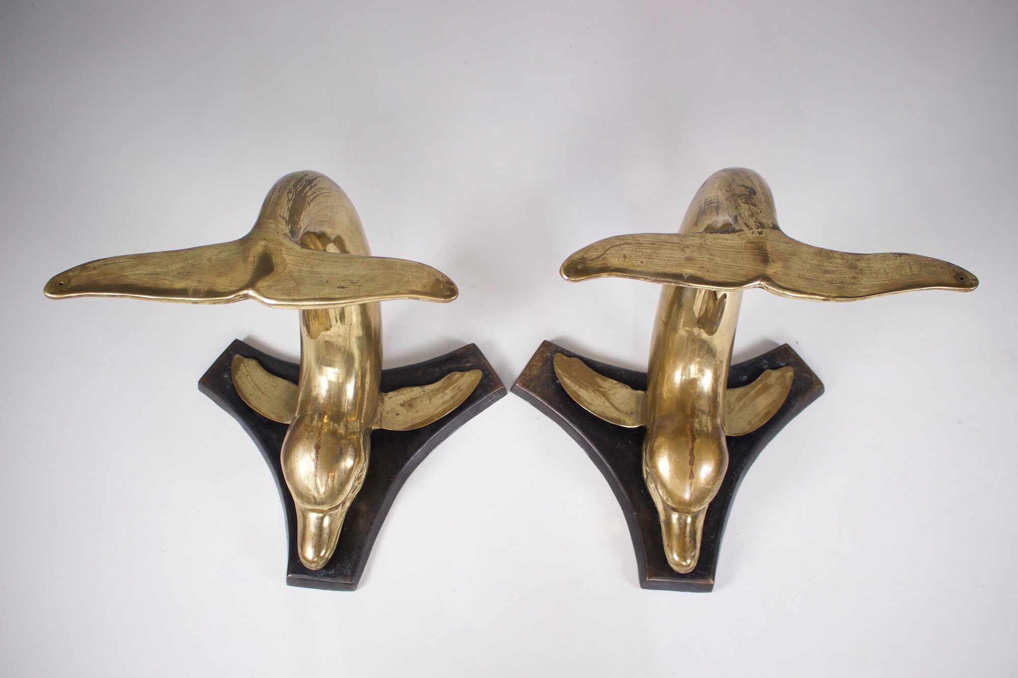 Solid brass dolphin console feet.