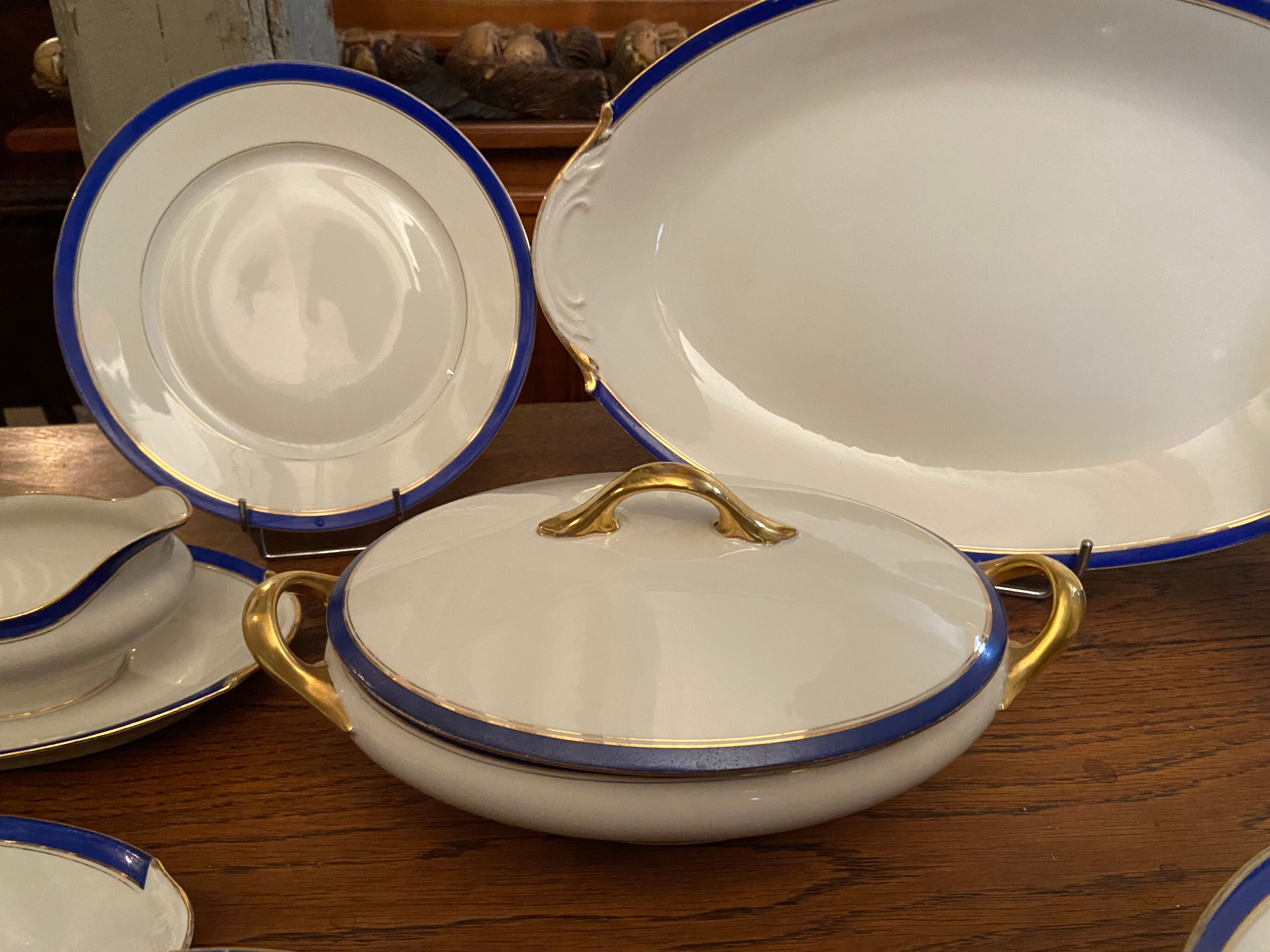 Service de table en porcelaine de Limoges à bandeau bleu sur fond blanc et or