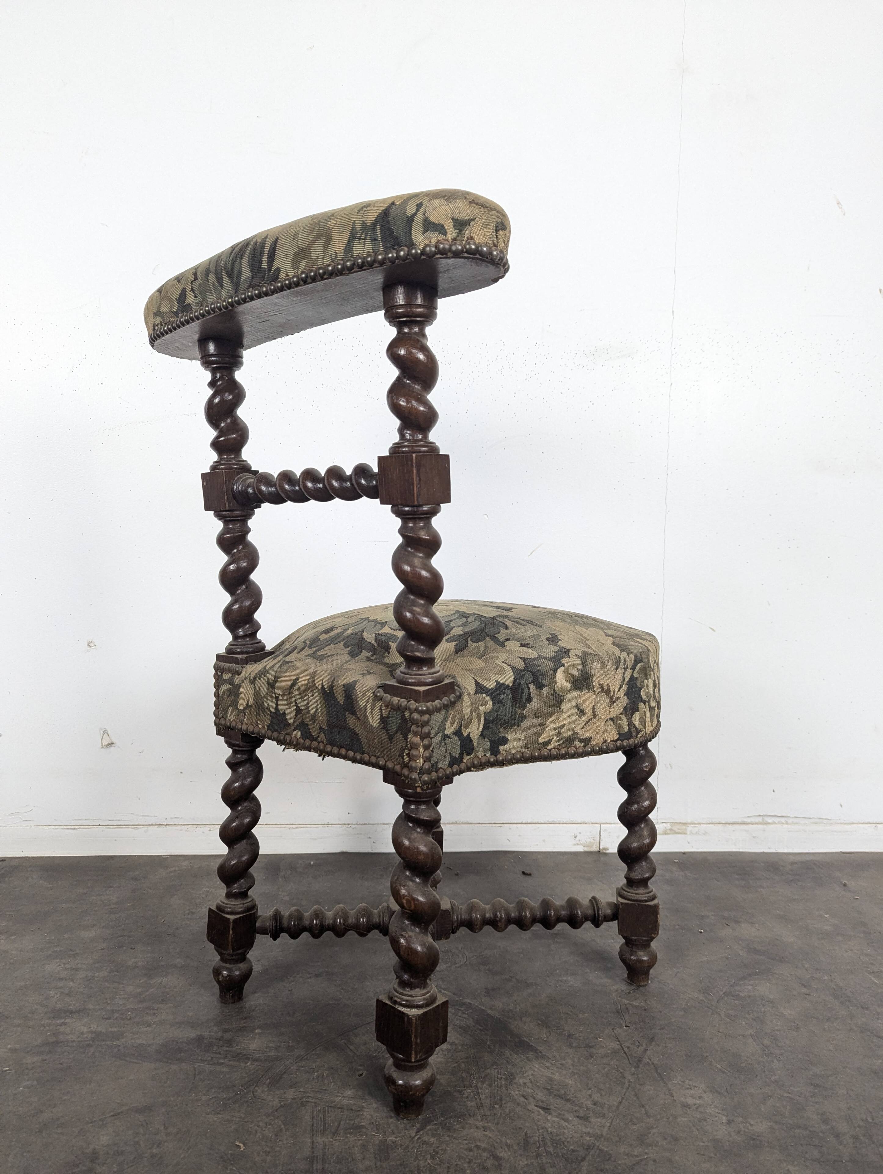 Napoleon III smoking chair in twisted blackened wood with foliage upholstery.