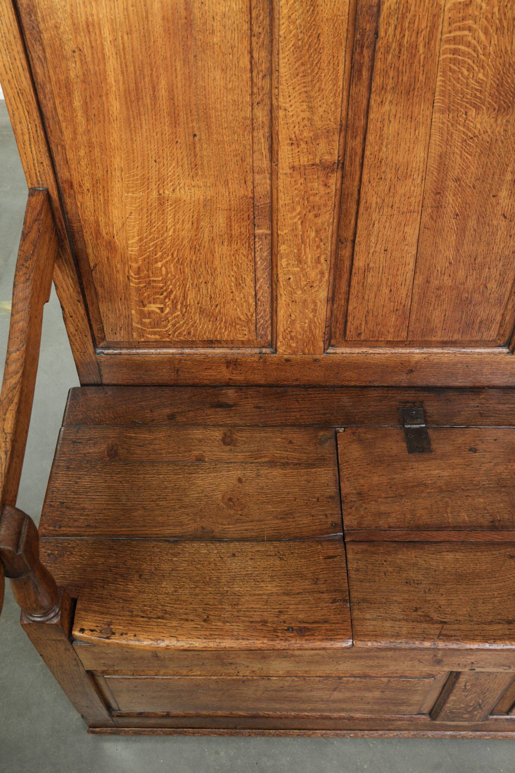 Antique English oak hall bench from the early 19th century with storage space
