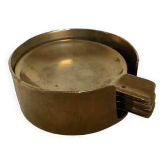 Four individual brass ashtrays