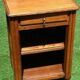 Golden oak bedside table topped with a moulded shelf niche with a shelf from the 1930s.