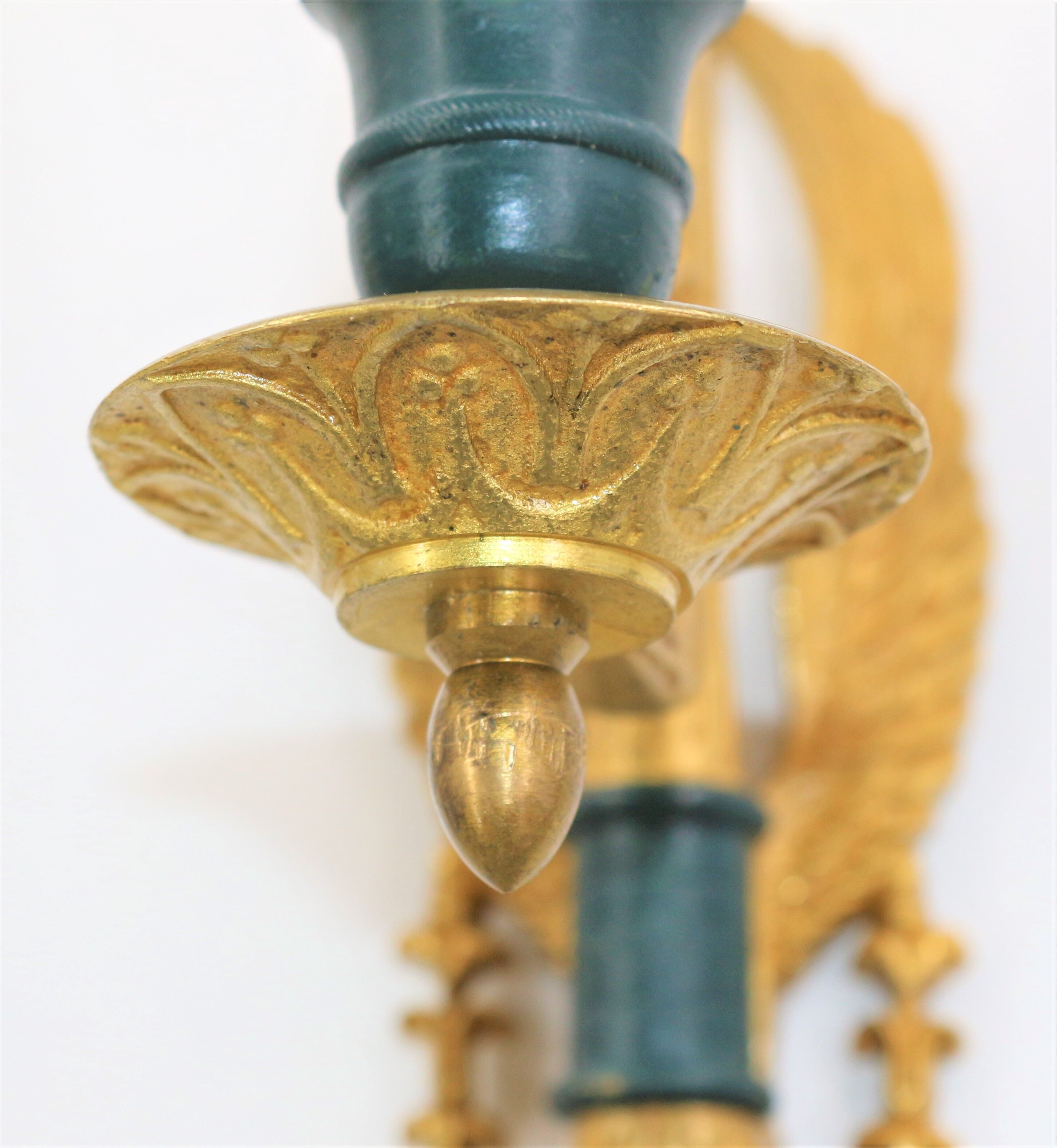 Pair of golden bronze wall lamps in triumphant empire swan style