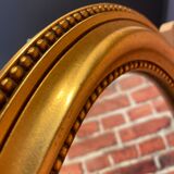 Oval mirror in a frame