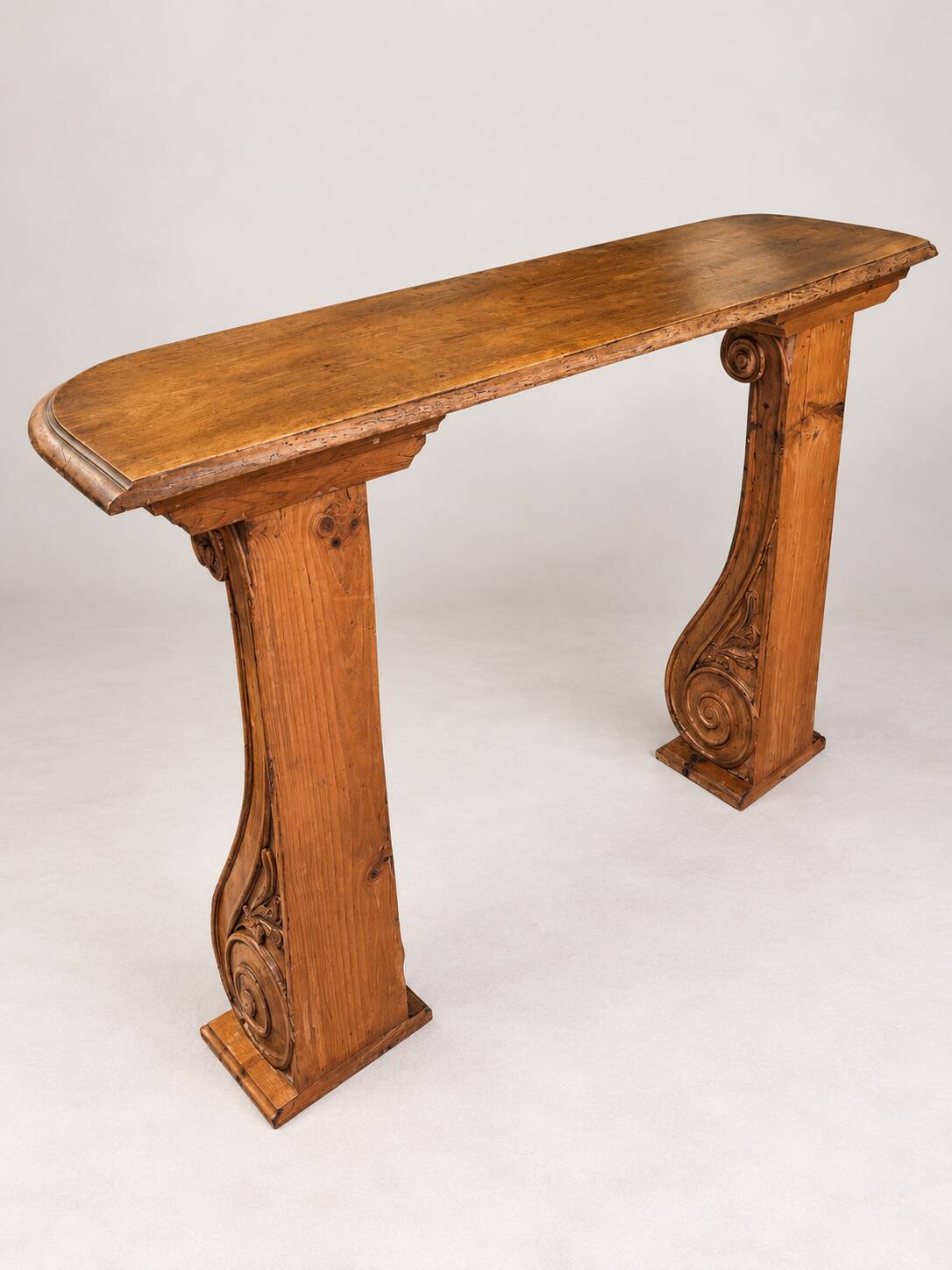 Old console in carved wood with scrolls