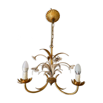 Golden metal chandelier decorated with flowers