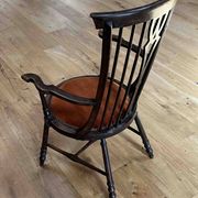 Windsor chair with comb back, stained wood and terracotta velvet.