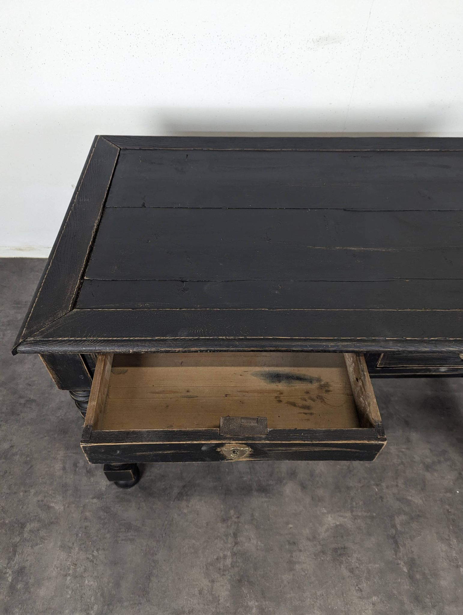 Louis XIII style desk in blackened wood with turned legs and two drawers.