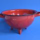 Vintage red enameled sheet metal colander
