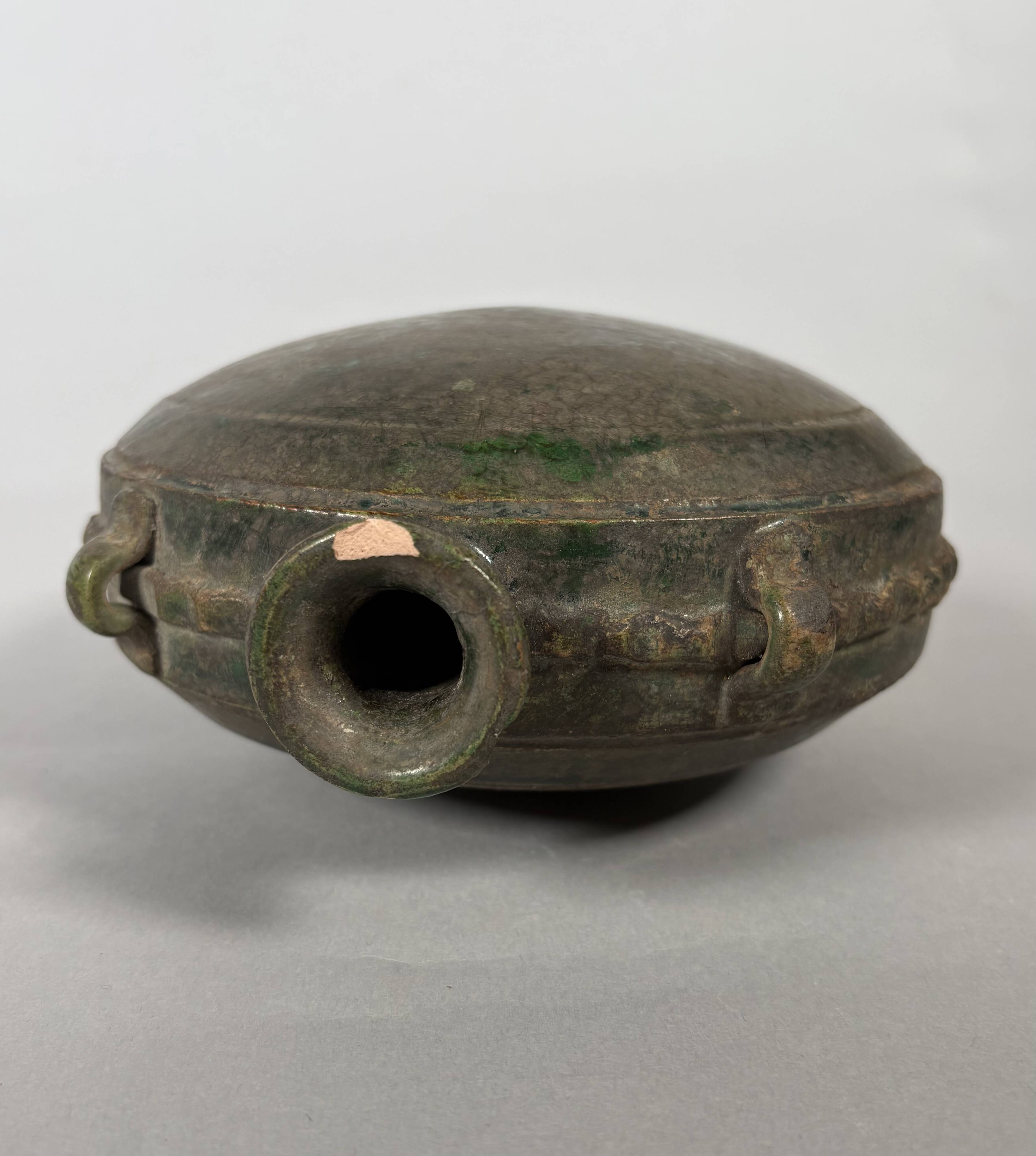 Nomadic rider's jug in green glazed earthenware, China, Tang Dynasty.