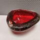 Small glass bowl in beautiful emerald red color with inlaid bubbles.