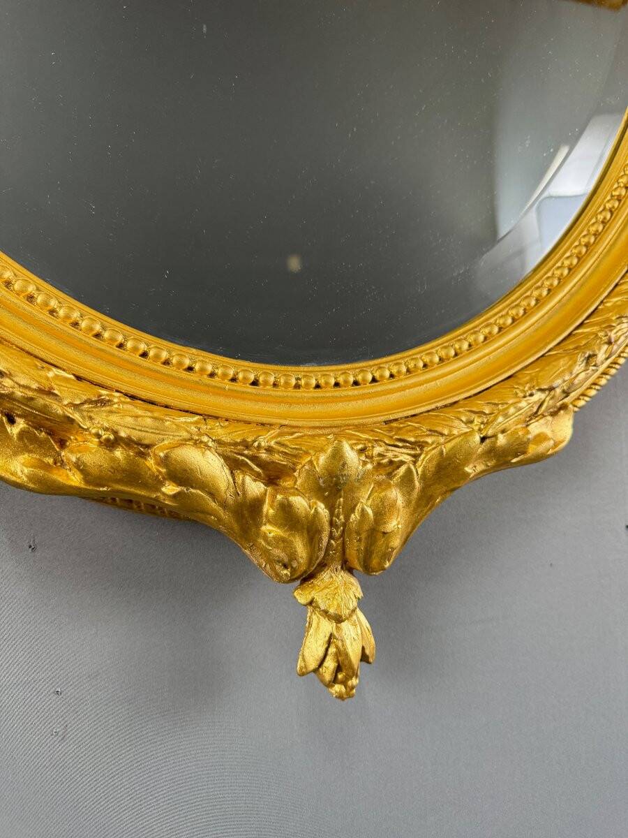 Miroir ovale doré style Louis XVI, XIXe siècle