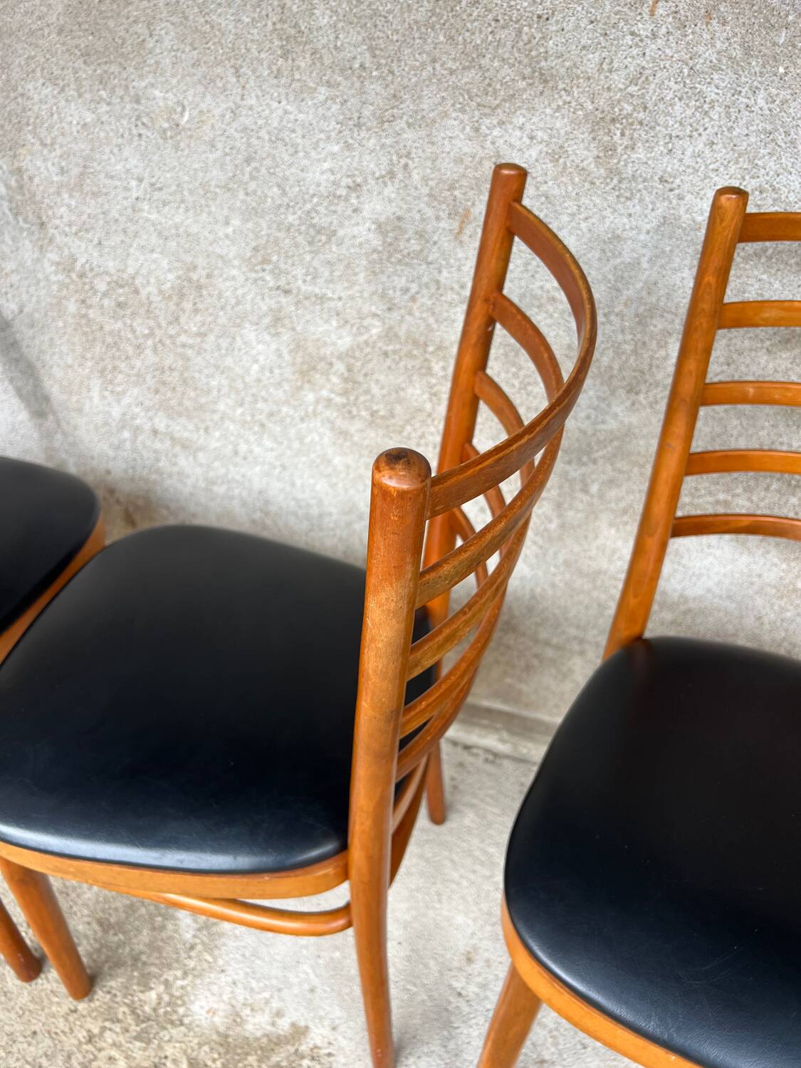 Set of 4 vintage wooden chairs with faux leather.