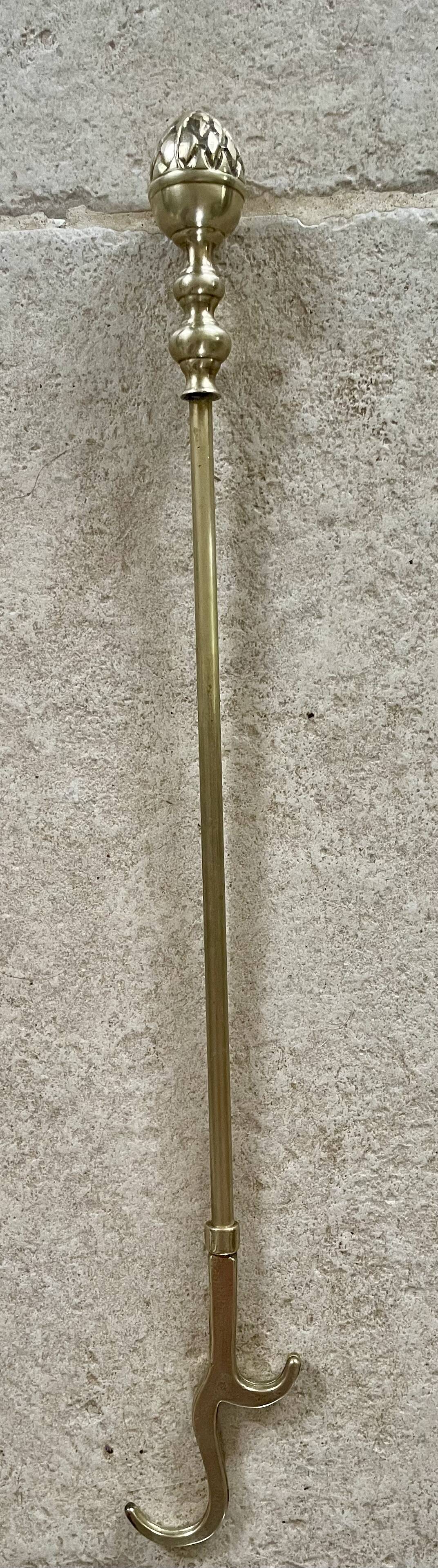 Brass fireplace tools in the style of Maison Baguès.