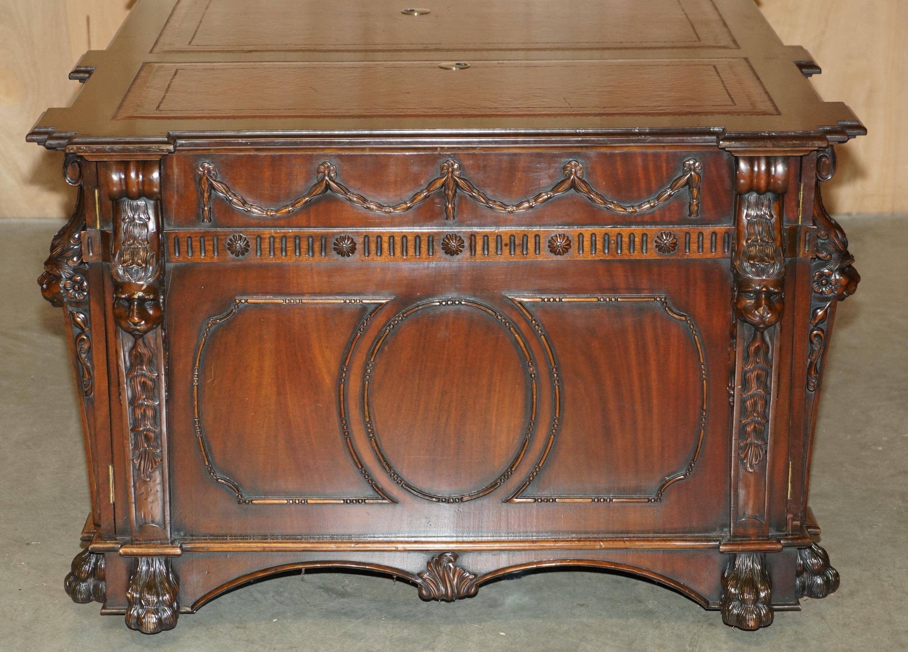Partner desk with two carved columns featuring lion heads, according to Thomas Chippendale, restored.