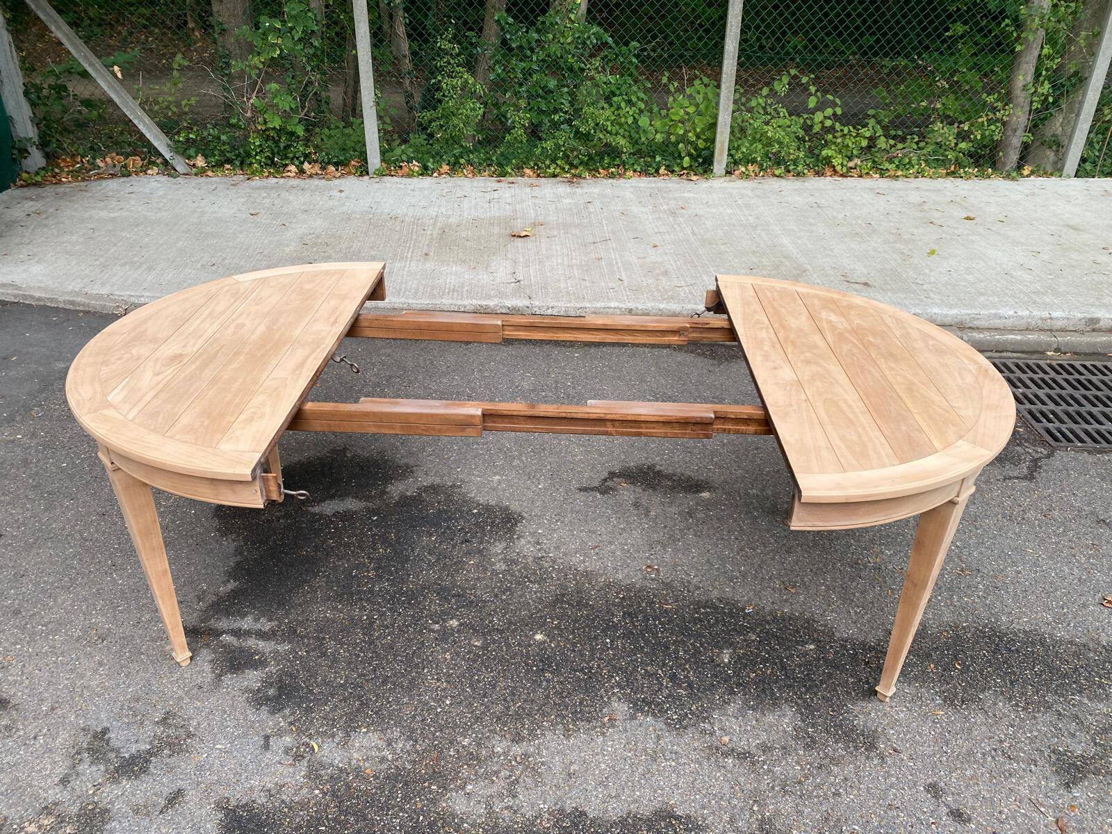 Round extendable dining table stripped in cherry wood Louis XVI René Trotel 1