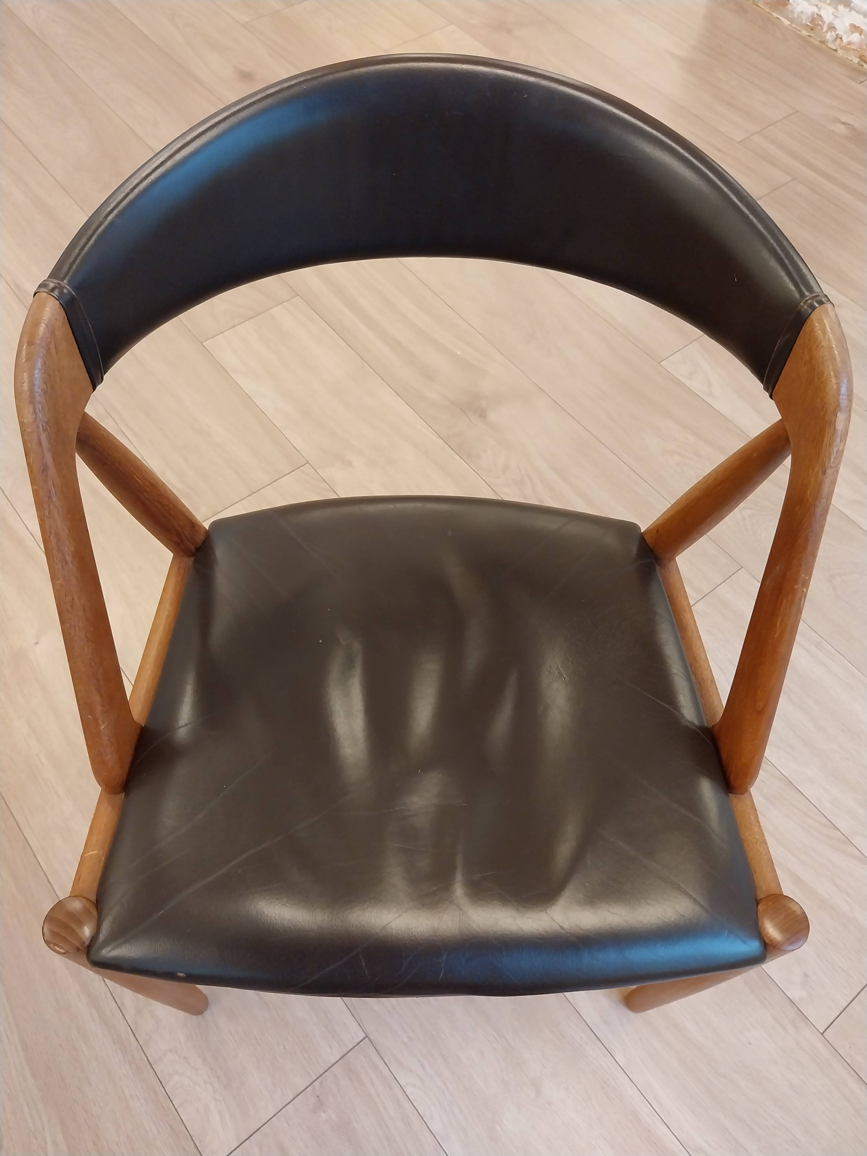 Set of 6 vintage Kai Kristiansen chairs in solid teak and black faux leather.