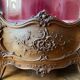 Large wooden display cabinet in Louis XV/rococo style with a strongly curved front.