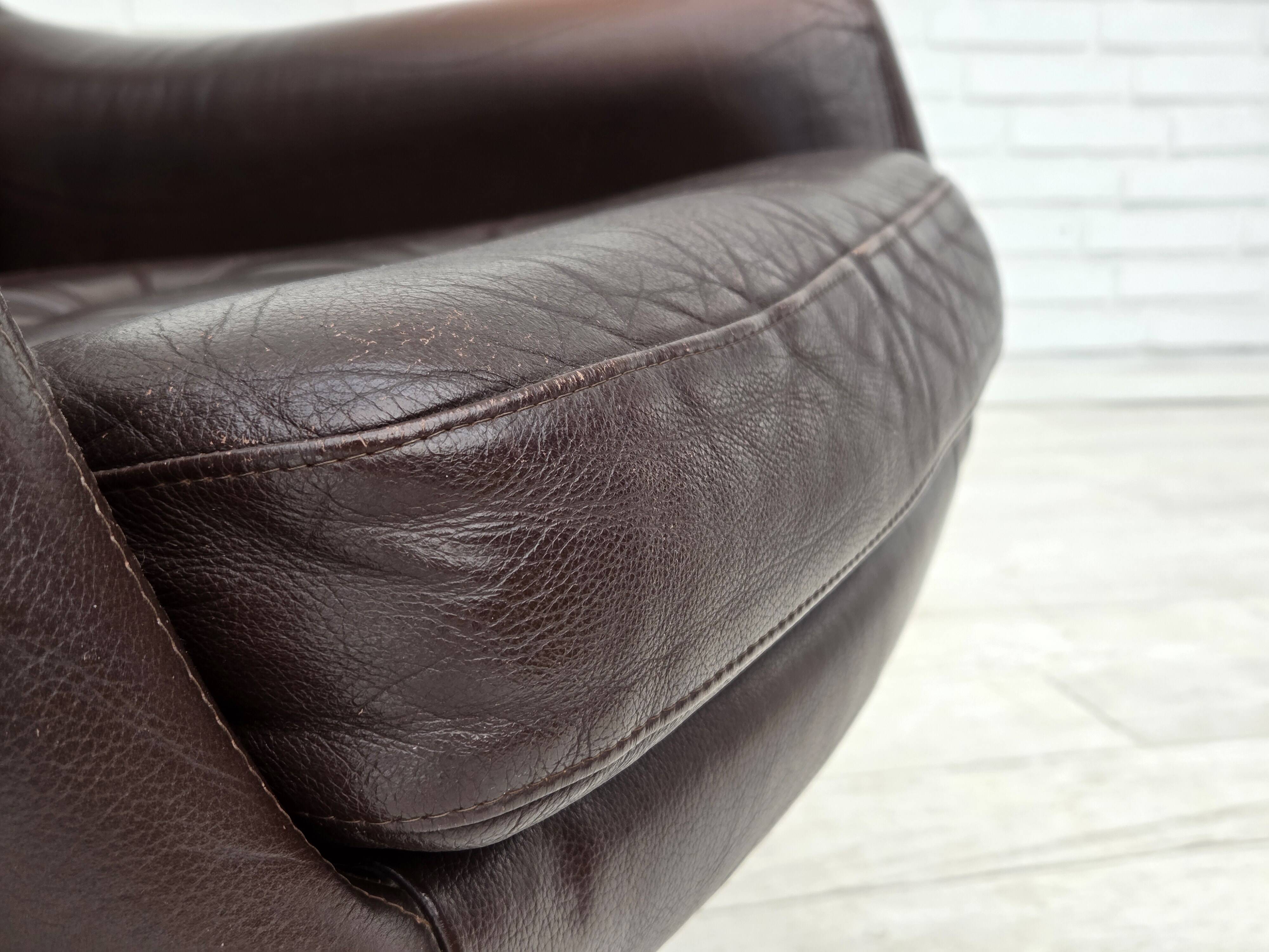 1970s, set of two swivel lounge chairs with footstool, leather.