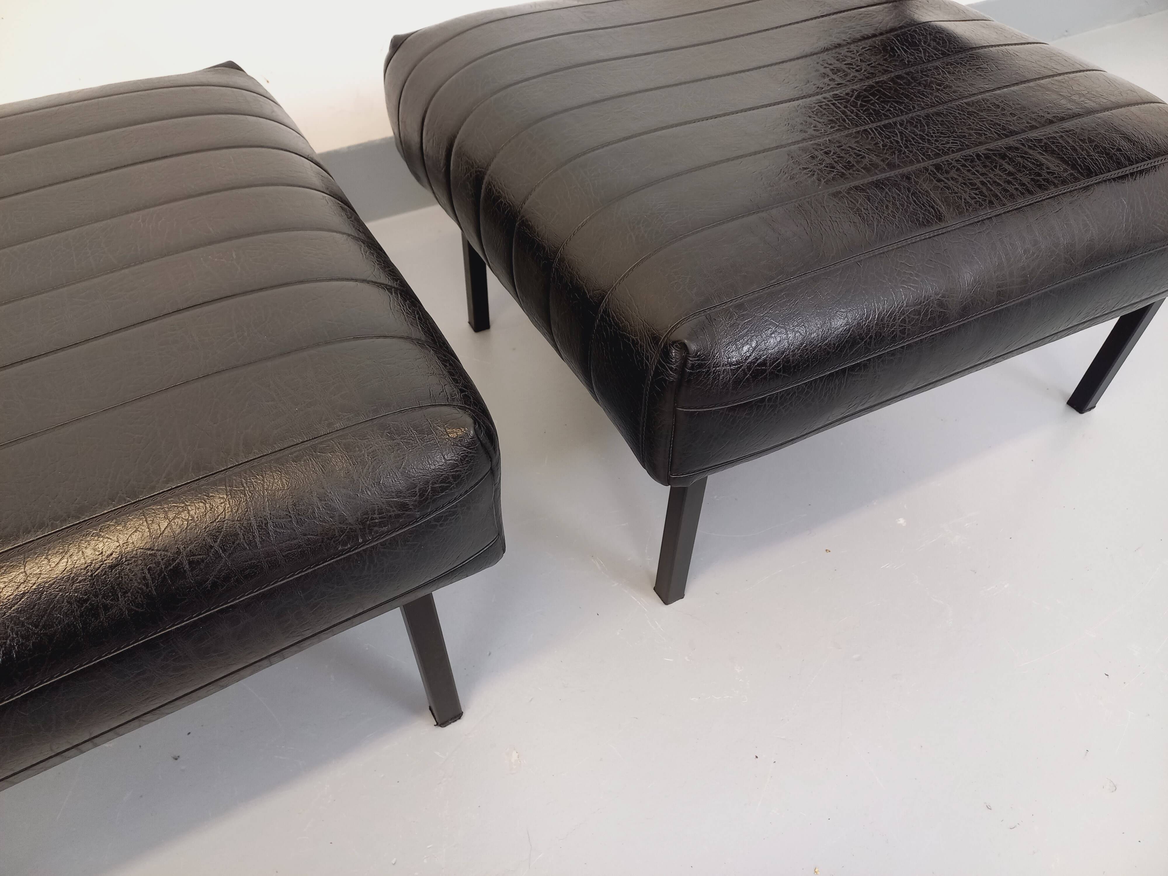 Set of 2 vintage modernist armchairs in black faux leather and metal.