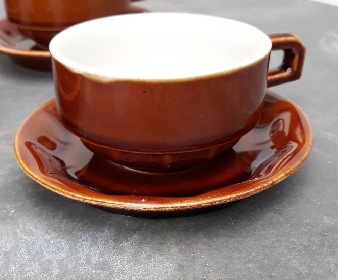 Old cups and under cups of coffee - brown ceramics typical of station buffets