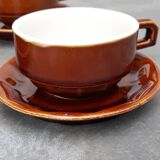 Old cups and under cups of coffee - brown ceramics typical of station buffets